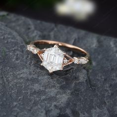 a diamond ring sitting on top of a rock