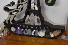 a shelf filled with crystals on top of a wooden table