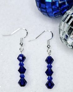 Handcrafted Dark Blue Faceted Bicone Glass Dangle Drop Earrings. These are the perfect earrings for any occasion. They pair well with any casual outfit and make a great gift for family and friends.  Perfect for a Christmas gift or gift for her. Deep Blue Faceted Beads. SHIPPING:  PROCESSING TIME IS CURRENTLY 1-2 DAYS FROM THE DATE OF PURCHASE. Processing time does not include shipping which is an extra 3-5 days. You will receive an email with tracking information once your order ships. Orders ar Blue Crystal Earrings With Dangling Beads For Gift, Blue Round Beads Crystal Earrings For Gift, Blue Round Bead Crystal Earrings For Gifts, Blue Beaded Earrings With Faceted Beads As Gift, Blue Crystal Round Bead Earrings For Gift, Blue Earrings For Christmas Gift, Blue Jewelry For Christmas Party, Blue Crystal Earrings With Faceted Beads As Gift, Blue Christmas Jewelry For The Holidays