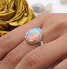 Ethiopian Opal Ring - 925 Sterling Silver Ring - Handmade Ring - Hippie Ring - Minimalist Gemstone Jewellery - Ring For Women   Gemstone Name - Ethiopian Opal Gemstone . Stone Quality - AAA. Ring Weight - 3.21 g  Length  - 1.4 cm Width -  1.1 cm Stone Shape - as Shown In The Picture. Ring Size - All Ring Size Available .  All Our Jewelry is Stamped 925  We serve complete 925 sterling silver Jewelry and genuine properties of the stone, Our all products are stamped 925. Product Quality and Packaging - Our all products are 925 Silver Stamped which shows that the product is genuine and authentic .The products are dispatched from the small business from UK so you get the product on time and the product packaging comes in bubble foil wrap with all the precautions taken primarily that your produc Silver Minimalist Opal Rings, Iridescent Sterling Silver Rings For Gifts, Silver Crystal Ring With Gemstone For Everyday, Everyday Silver Crystal Ring With Gemstone, Silver Crystal Gemstone Ring For Everyday, Spiritual Opal Rings, Minimalist Adjustable Silver Opal Ring, Iridescent Gemstone Promise Ring, Silver Everyday Rings With Gemstone