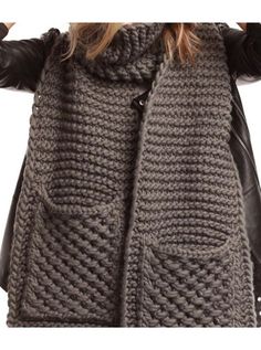 a woman wearing a gray knitted vest