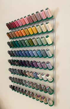 there is a rack that has many different colors of thread on it