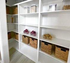 the shelves are filled with baskets and containers for food items to be stored on them