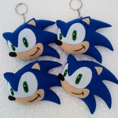 three sonic the hedgehog keychains with green eyes