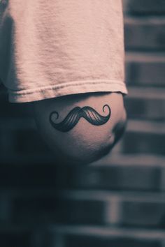 a person with a mustache tattoo on their stomach