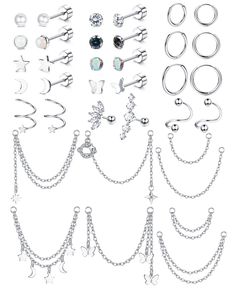 several pairs of earrings and chains on a white background