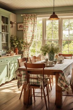 a dining room table and chairs in front of a window