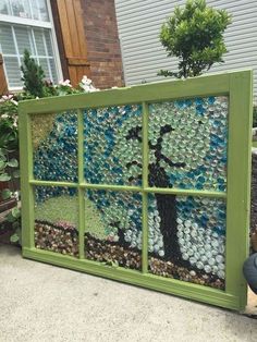 an old window is transformed into a garden art project