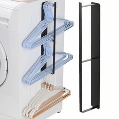 clothes hangers are attached to the side of a washing machine and next to it is a dryer