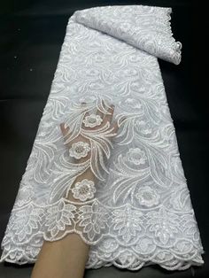 elevate your designs with our exquisite Lace Fabric. this  lace fabric is perfect for wedding gowns, evening dresses, and other special occasion outfits. Explore our collection now and unleash your creativity. Luxury White Embroidered Fabric For Formal Occasions, Luxury Elegant Lace Fabric, Luxury Tulle Lace For Wedding, Luxury White Gown With Lace Patchwork, Luxury Crochet Lace For Party, Luxury Organza Lace For Wedding, Luxury Lace Fabric For Wedding, Luxury Traditional Lace Dresses, Luxury Embellished Lace For Wedding