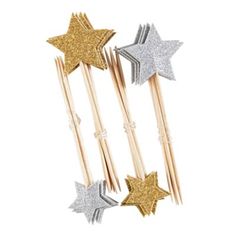 three gold and silver stars on sticks with toothpicks in the shape of stars