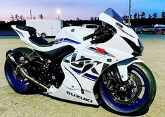 a white and blue motorcycle parked in a parking lot