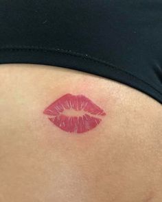 a woman's stomach with red lipstick on it