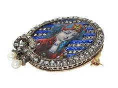 A stunning example of antique enamel work, this Victorian era diamond portrait brooch with a fold down pendant bail is a truly exquisite artifact. A young woman — luxuriously outfitted in the vestments of the early 16th century including slashed sleeves, an elaborate bejeweled headdress, collar necklace and emerald and pearl brooch — is set against a backdrop of diagonal stripes. The stripes consist of rose-cut diamonds and deep blue enamel adorned with white fleurs de lis. A border of rose-cut Victorian Brooches For Ceremonial Occasions, Victorian Oval Brooch Jewelry, Slashed Sleeves, Luxury Victorian Brooches With Cabochon, Victorian Enamel Brooches For Gifts, Victorian Oval Brooch, Victorian Silver Enamel Brooches, Pendant Bail, Jewellery Marketing