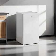 a white refrigerator freezer sitting on top of a kitchen floor