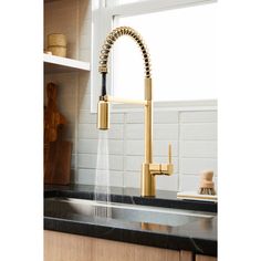 a kitchen faucet with a black counter top