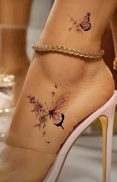 a woman's foot with butterfly tattoos on her left ankle and the bottom part of her leg