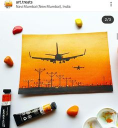 an airplane is flying in the sky with oranges and yellows on it, next to some candy