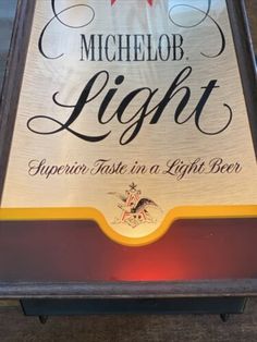 a sign for michelob light on the side of a building with red and white lettering