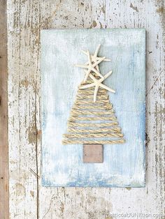 a small christmas tree made out of twine on top of a wooden paneled wall