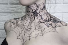 a woman with a spider web tattoo on her neck