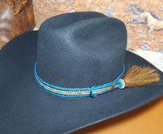 Turquoise/Black/Brown Braided Horse Hair Adjustable Hat Band with 1 Side Tassels, a loop and sliding knot that make this hatband a great fit for most hats. This stunning hat band is made from genuine braided horse hair and will compliment your favorite cowboy hat.   - 3 braided strands are sewn together to create this gorgeous hatband. - Incudes 1 horse hair tassels that measure 3 1/4" long - Hat band measurements: approximately adjusts to 27" around and is 3/4 inch wide - Hat bands are shown on a size 7 hat.  Hats are not included. - See my horse hair KEEPSAKES to have a hat band made from your horse's hair:  https://www.etsy.com/shop/BlueEyesDesignsHB?ref=seller-platform-mcnav§ion_id=43697745 - See my HORSE HAIR hat bands:  https://www.etsy.com/shop/BlueEyesDesignsHB?ref=shop-header-name Handmade Southwestern Blue Hat Band, Adjustable Turquoise Hat Bands For Country Events, Handmade Blue Hat Bands For Rodeo, Handmade Blue Hat Band For Rodeo, Western Blue Hat Bands For Ranch, Adjustable Blue Southwestern Hat Band, Adjustable Southwestern Blue Hat Band, Flat Brim Blue Hats For Ranch, Blue Flat Brim Hat For Ranch