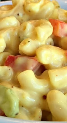 macaroni and cheese with tomatoes in a bowl