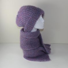 a knitted purple hat and scarf on a mannequin's head,