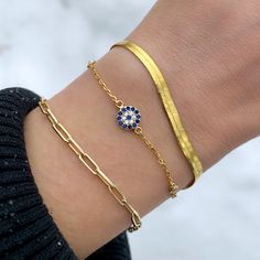 Since the Evil Eye is an ancient symbol of protection, we choose to wear it on our wrists for good luck. This dainty Alexandra Marks Evil Eye Tennis Bracelet is the perfect addition to your everyday wear, featuring a Pave’ CZ Disc design and bezel stones. Wearing a good luck symbol has never looked prettier, whether you wear it alone or stacked with other arm candy. Details:• Round Brilliant Cubic Zirconia Stones • 18kt Yellow Gold Plated or Rhodium Plated Sterling Silver • Bracelet Length: adju Gold Adjustable Evil Eye Bracelet, Adjustable Gold Evil Eye Bracelet, Adjustable Gold Evil Eye Symbolic Bracelet, Gold Round Evil Eye Bracelet For Friendship, Gold Evil Eye Bracelet For Friendship, Gold Symbolic Bracelets For Everyday, Everyday Symbolic Gold Bracelets, Everyday Symbolic Bracelets, Adjustable Gold Evil Eye Bracelet For Everyday