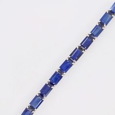 Indulge in the timeless allure of our 18K White Gold Octagon Blue Sapphire Tennis Bracelet—an exquisite blend of sophistication and elegance. Crafted with meticulous precision, this bracelet features a stunning array of octagon-cut blue sapphires, each gemstone meticulously set in lustrous white gold Timeless Blue Bracelet For Formal Occasions, Luxury Blue Sapphire Bracelets, Timeless Blue Asscher-cut Jewelry, Formal Blue Bracelet With Polished Finish, Blue Bracelets With Polished Finish For Formal Occasions, Modern Blue Gemstone Bracelet, Blue Rectangular Faceted Jewelry, Modern Blue Gemstone Bracelets, Luxury Blue Gemstone Tennis Bracelet