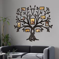 a living room with a couch and tree wall decal