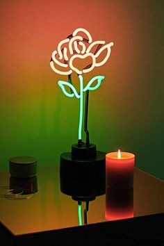 a lit up flower sitting on top of a table