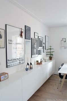 a white room with pictures on the wall