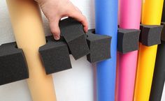 a person is placing foam blocks on the wall