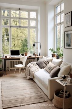 a living room filled with furniture and lots of windows