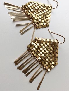 Modern fringed earrings feature panels of gold metal mesh reclaimed from a vintage, mid-century purse (circa 1960-1980s) atop glittering stands of hand hammered, 14k gold filled drops. Ruoko Mesh Earrings measure 2.25" tall x 1.5" wide. 14 karat gold filled frames and earrings. Each earring signed with our logo link. Vintage Gold Chandelier Earrings For Festive Occasions, Glamorous Gold Fringe Earrings, Festive Gold Vintage Chandelier Earrings, Festive Vintage Gold Chandelier Earrings, Gold Fringe Metal Chandelier Earrings, Gold Fringe Earrings In Brass, Gold Fringe Chandelier Earrings As Gift, Gold Fringe Chandelier Earrings, Gold Beaded Long Drop Earrings