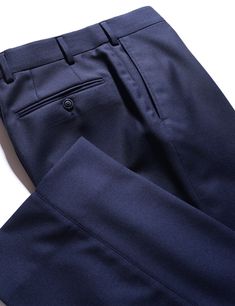 When selecting a separate trouser, you want something that can wear many hats and be a workhorse in your wardrobe. This Super 130s wool cloth is a classic, understated twill weave in a sturdier construction, giving it an understated look, solid drape and high level of durability suitable for frequent wear. Consider this a go-to, do-anything staple in your wardrobe that you can dress up or down as the occasion demands. FABRIC AND TRIMS: Woven in Italy by Drago, this Super 130s wool twill is made from a slightly thicker yarn, and woven with a dense construction, to give it a sturdy, substantial drape, while still preserving a soft, luxurious feel. 100% wool - Super 130s yarn count 310 grams/meter SEASONALITY: A medium-heavy weight suitable for any time of year, but perhaps not the very hotte Classic Navy Dress Pants For Business Casual, Classic Navy Dress Pants With Welt Pockets, Tailored Classic Navy Pants, Classic Winter Dress Pants, Tailored Navy Dress Pants With Welt Pockets, Navy Tailored Dress Pants With Welt Pockets, Tailored Elegant Navy Pants, Elegant Tailored Navy Pants, Classic Navy Formal Bottoms