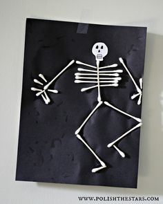 a paper cut out of a skeleton on a wall