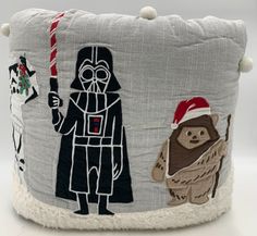 a star wars themed pillow with an image of darth vader and chew toy