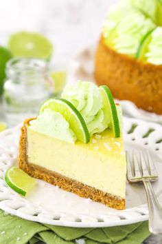 a slice of key lime cheesecake on a white plate with a fork next to it