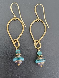 Add a little sass to your style with these turquoise czech glass saturn beads with gold wash suspended from hammered brass teardrops.  Brass ear wires are nickel free and secured with silicone backs. Turquoise Czech Glass Earrings With Faceted Beads, Blue Czech Glass Wire Wrapped Beaded Earrings, Blue Teardrop Czech Glass Beaded Earrings, Blue Faceted Beads Earrings In Czech Glass, Chip Bead Jewelry, Turquoise Czech Glass Dangling Beads Earrings, Jewelry Making Earrings, Beaded Earrings Diy, Gold Wash