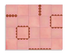 a pink tile with brown dots and squares on the top, as if it were made out of paper