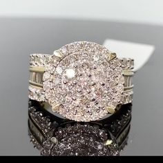 a diamond ring is sitting on top of a black surface