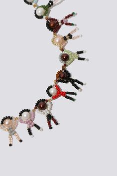 a group of people made out of bead and glass beads on a white background