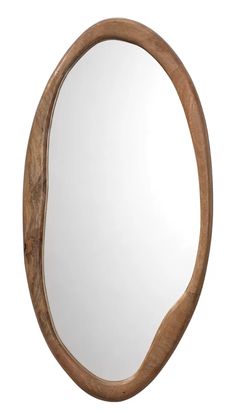 an oval wooden mirror hanging on the wall next to it's reflection in a white background