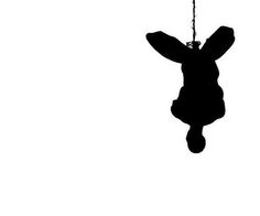 an animal hanging from a chain on a white background in the shape of a rabbit