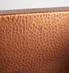 a close up view of a shiny brown leather surface on a white tablecloth with an animal print pattern