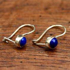 Like the lovely contemporary dancer Isadora Duncan, this "night-out" design will sparkle long past midnight. Available in amethyst, blue topaz, iolite, chrysoprase, lapis lazuli, moonstone, ruby, turquoise and smoky topaz. 24k gold vermeil, with hinged backs for pierced ears. Size: 3/4" tall Blue Brass Earrings With Natural Stones, Blue Earrings With Natural Stones, Spiritual Blue Jewelry With Ear Wire, Spiritual Blue Earrings With Natural Stones, Spiritual Blue Brass Jewelry, Turquoise Wedding Jewelry, Iolite Jewelry, Isadora Duncan, Accessory Design