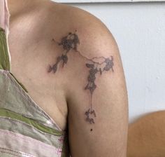 a woman with a tattoo on her shoulder