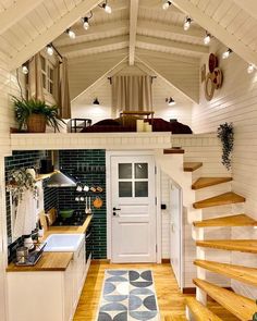 a tiny house with stairs leading up to the kitchen